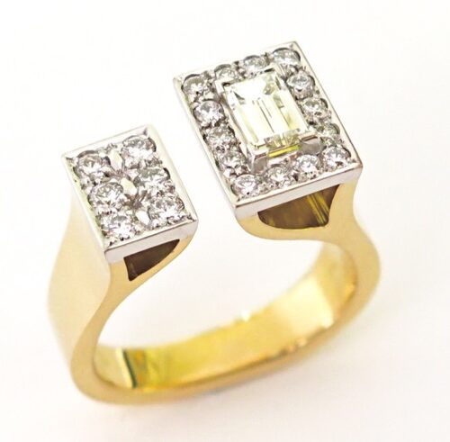 18ct yellow and white gold handmade ring inspired by 1970s upsweep ring designs. Set with 1 baguette diamond and 20 round brilliant cut diamonds