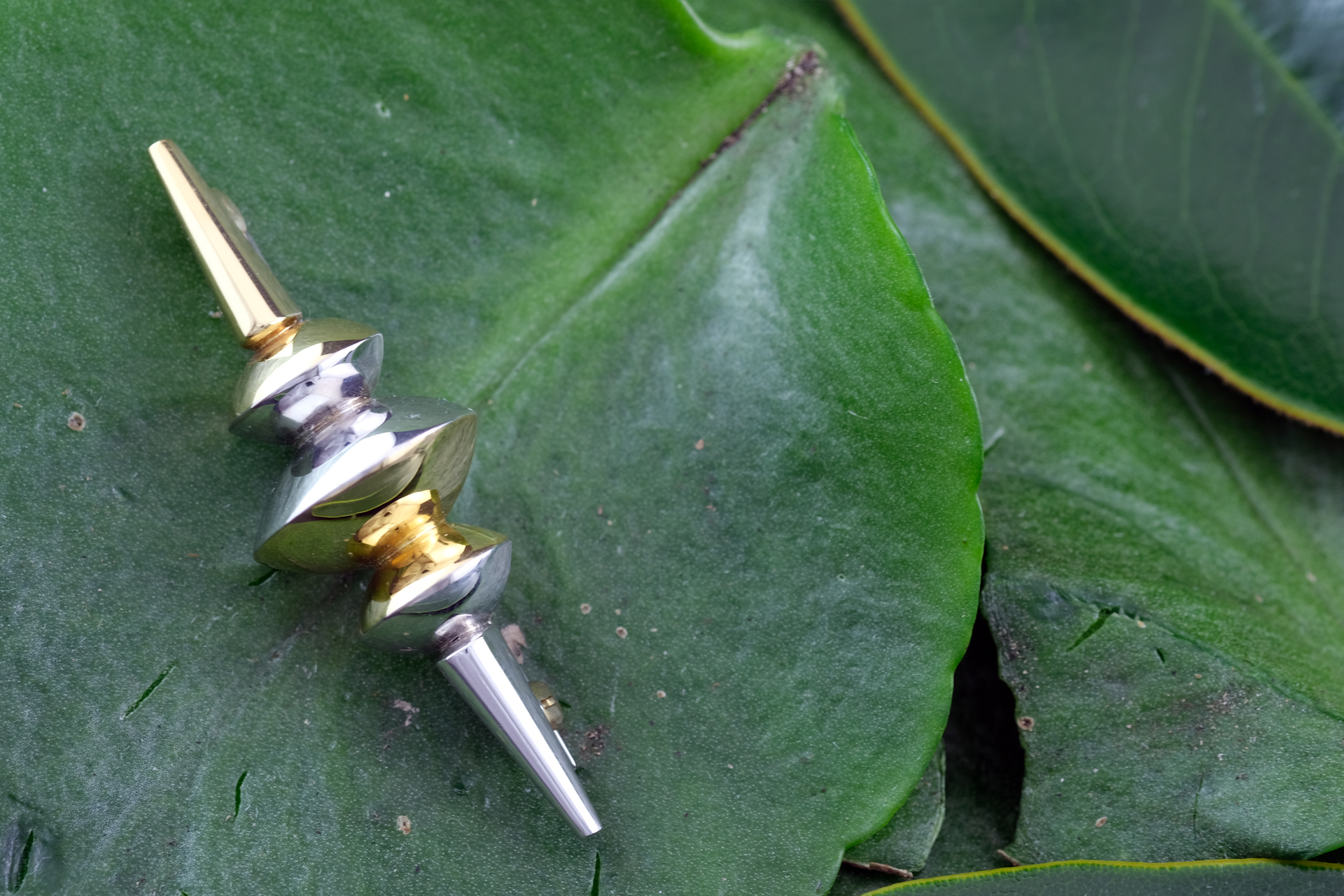 White and yellow gold satellite disc brooch