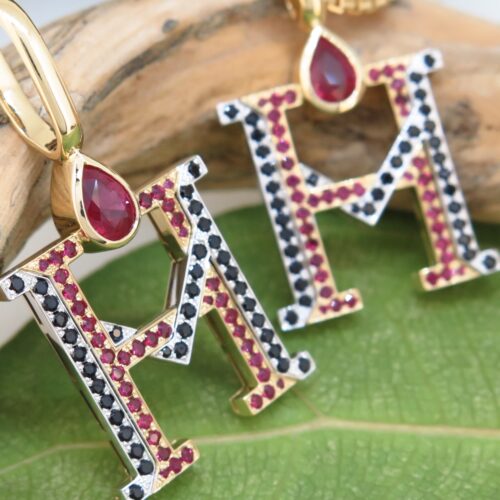 Handmade 18ct yellow gold and platinum pendants set with fine burmese rubies and black spinels.