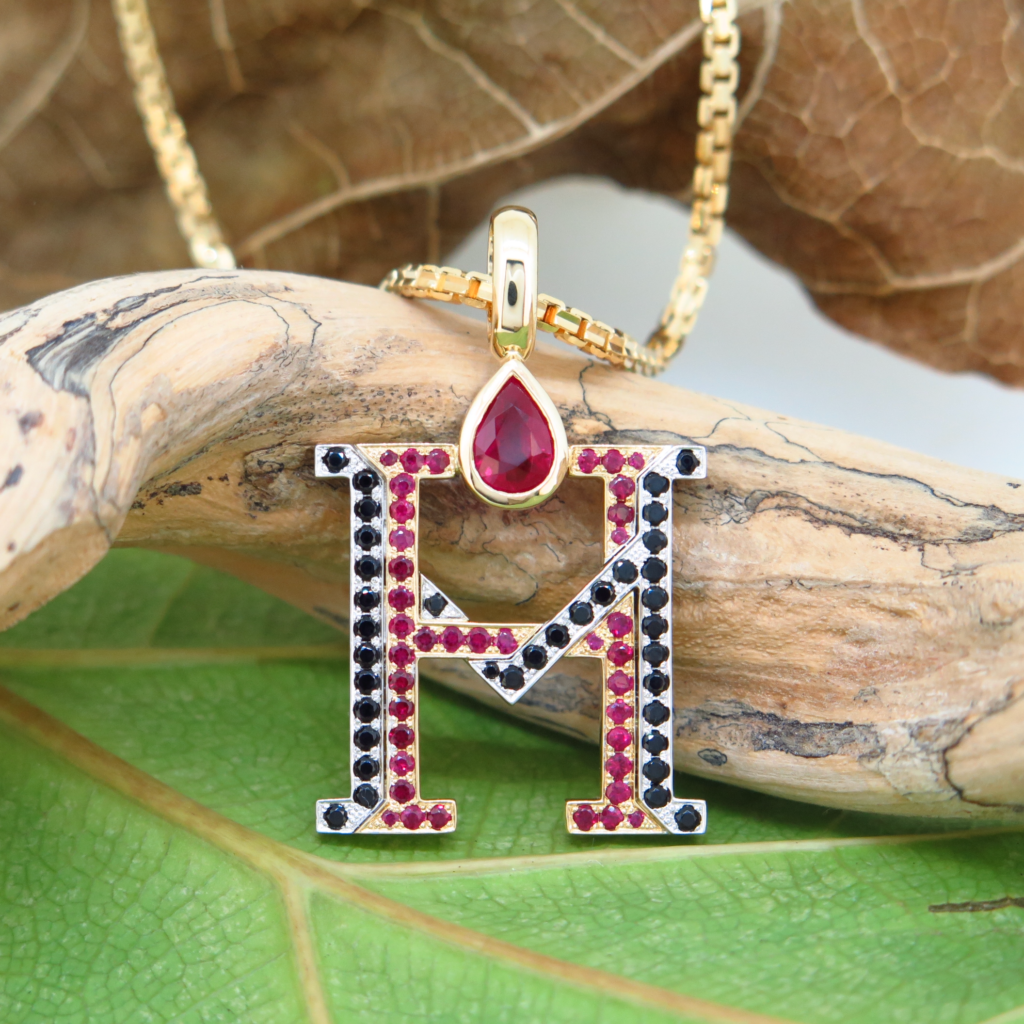 Handmade 18ct yellow gold and platinum pendants set with fine burmese rubies and black spinels.
