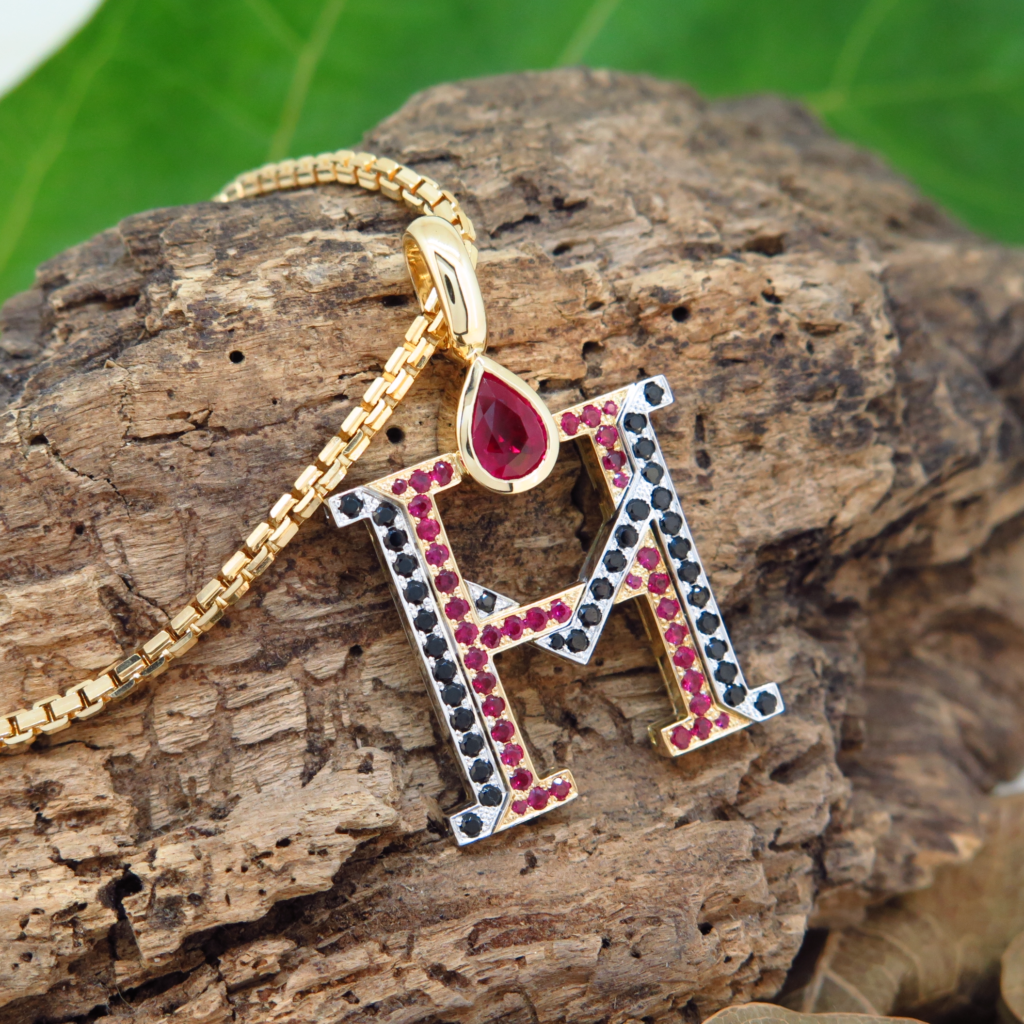 Handmade 18ct yellow gold and platinum pendants set with fine burmese rubies and black spinels.