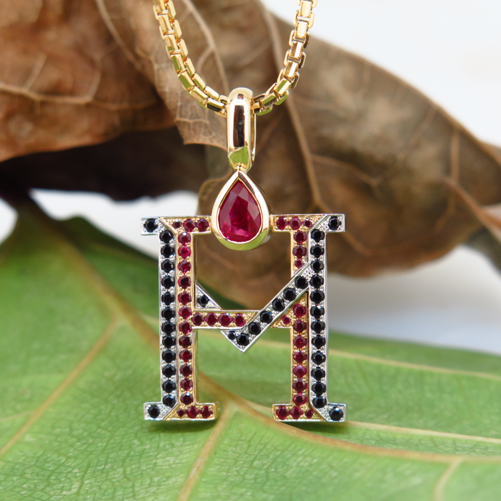 Handmade 18ct yellow gold and platinum pendants set with fine burmese rubies and black spinels.