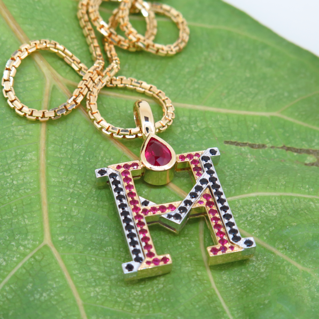 Handmade 18ct yellow gold and platinum pendants set with fine burmese rubies and black spinels.