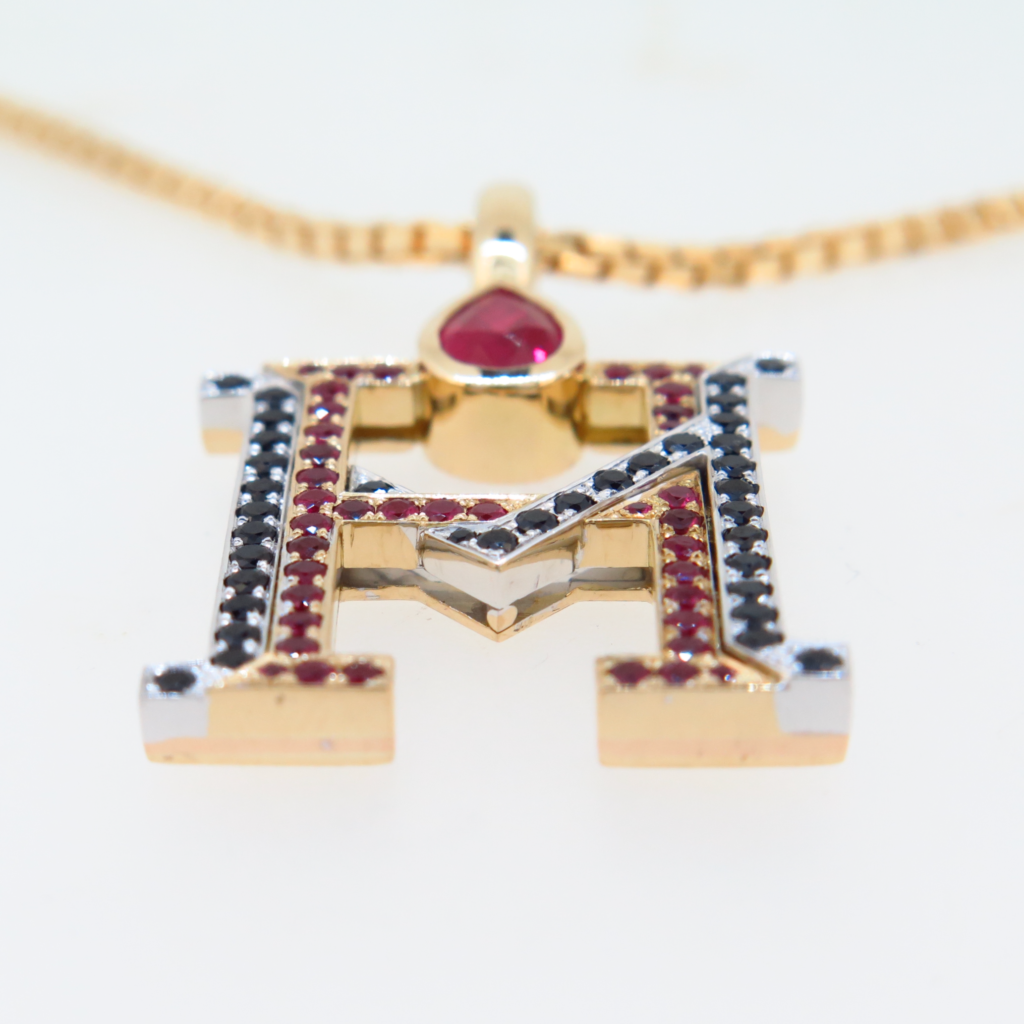 Handmade 18ct yellow gold and platinum pendants set with fine burmese rubies and black spinels.